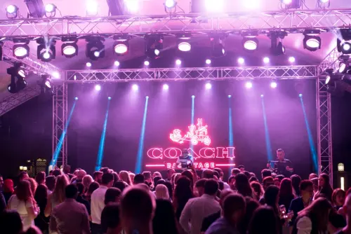 This picture shows a stage behind a crowd on a music event.