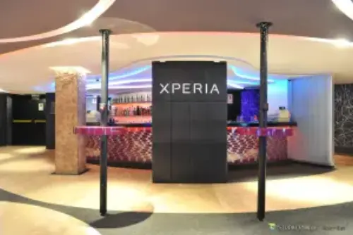 Here we can see a bar area with a scustomized decor and architectural elements, layed out for a product launch.