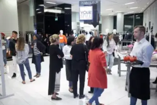 Here is a picture of a fashion event that we hosted. Visible is a crowd of people as well as a waiter with cocktails.