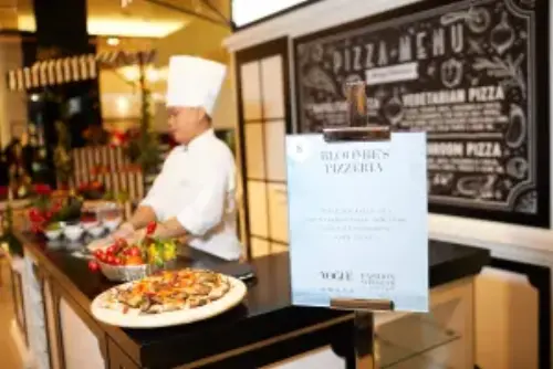 This is a close-up shot on a chef preparing a pizza-menu on one of our corporate events.